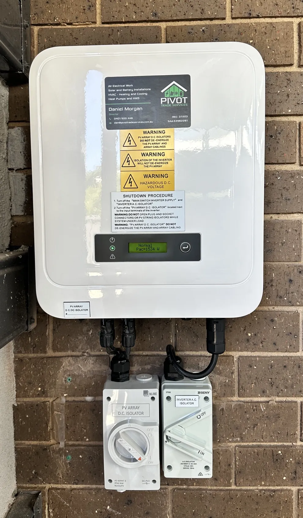 Solar inverter and two isolators mounted on a brick wall